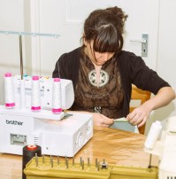 Tara using the Serger - which looks challenging to thread up!